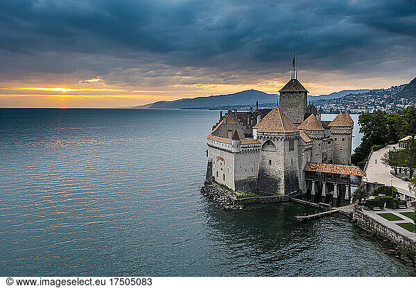 Switzerland  Canton of Vaud  Veytaux  Aerial view of Lake Geneva and Chillon Castle at cloudy sunset