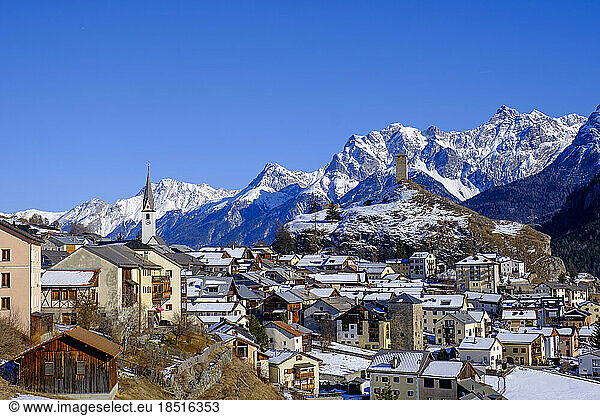 Switzerland  Graubunden Canton  Ardez  View of winter town in Engadine valley with mountains in background