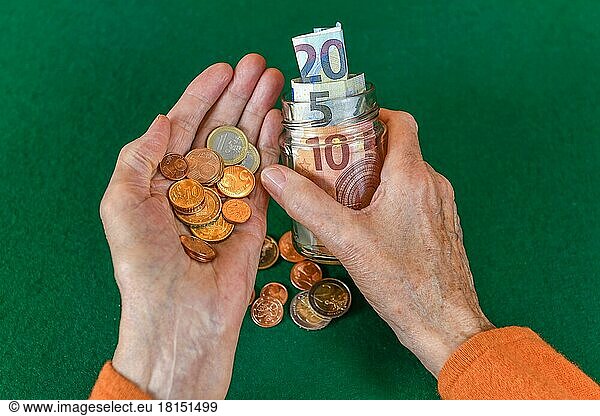 Symbol photo  pension  senior  hands  money  piggy bank