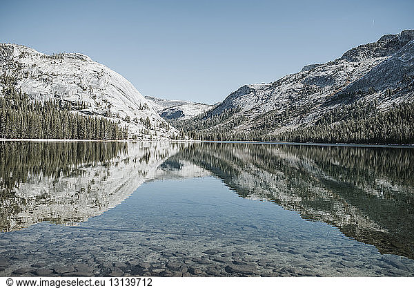 Symmetry view of lake by mountains against clear sky at Yosemite National Park