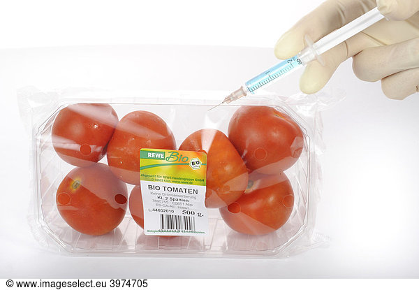 Syringe identification in tomato with BIO on the label  symbolic picture  fraud with food with the BIO label