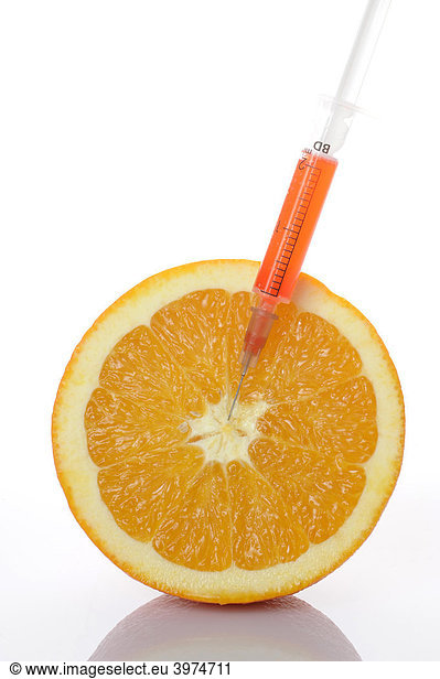Syringe in orange  symbolic picture  genetically modified foods