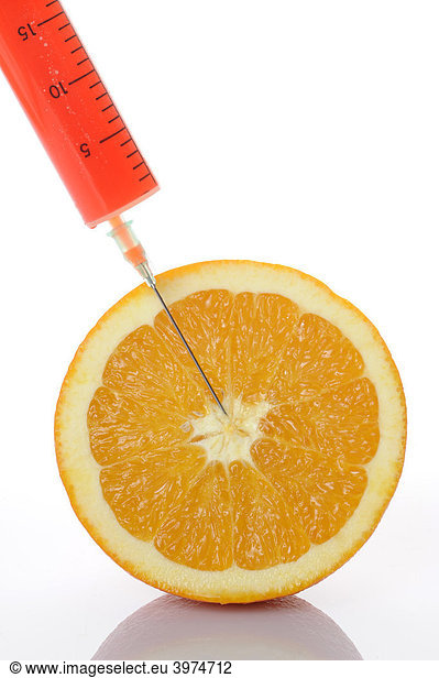 Syringe in orange  symbolic picture  genetically modified foods