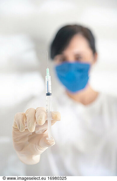Syringe  medical injection in hand. Vaccination kit. Nurse