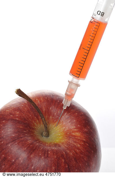 Syringe sticking in an apple  symbolic image for GM  genetically modified  food