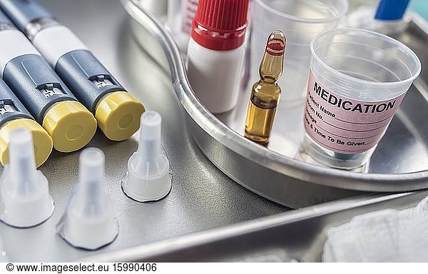 Syringes of insulin medication next to medicine vials prepared in hospital  conceptual image .