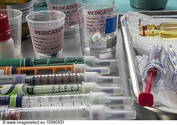 Syringes of insulin medication next to medicine vials prepared in hospital  conceptual image.