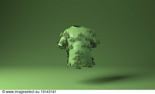 T shirt covered with green plants against green background
