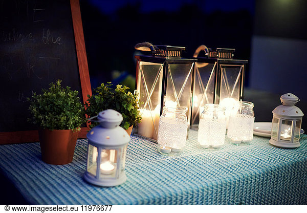 Table set  outdoors  with illuminated lanterns