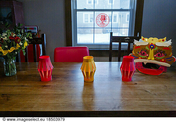 Table with paper lanterns and Chinese Lion for Lunar New Year