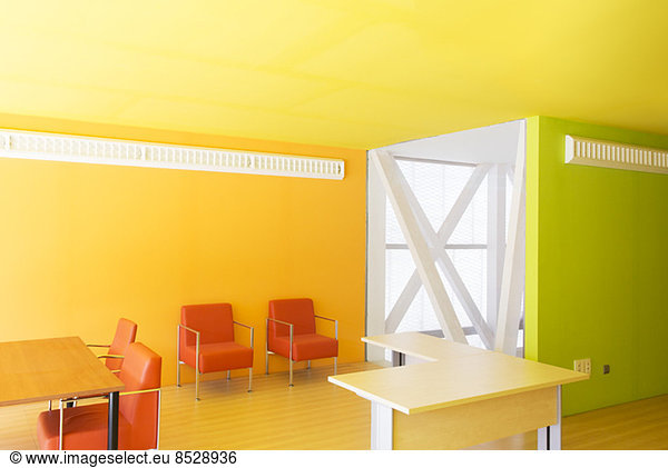 Tables and chairs in bright office