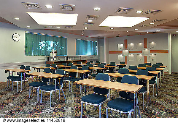 Tables and chairs in empty classroom