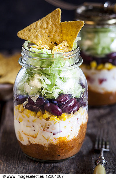 Taco salad  chili con carne  sour cream  corn  kidney beans  iceberg lettuce in a jar  nacho chips
