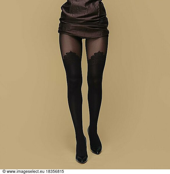 Tall slim female legs in tights. Pantyhose with prints