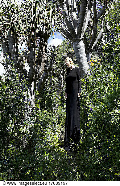 Tall woman standing amidst trees in forest Grand Canary  Canary Islands  Spain