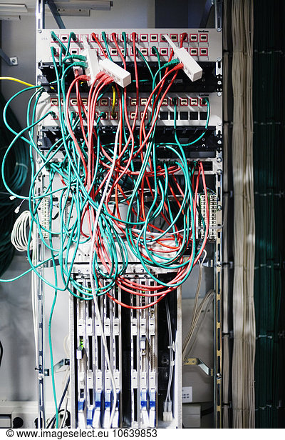 Tangled cables hanging from a server