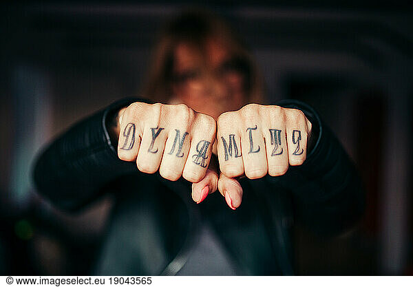 Tattoo text on fingers.