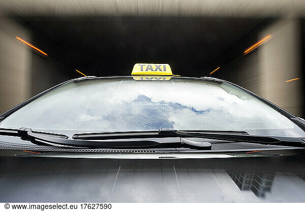 Taxi cab emerging from a garage.