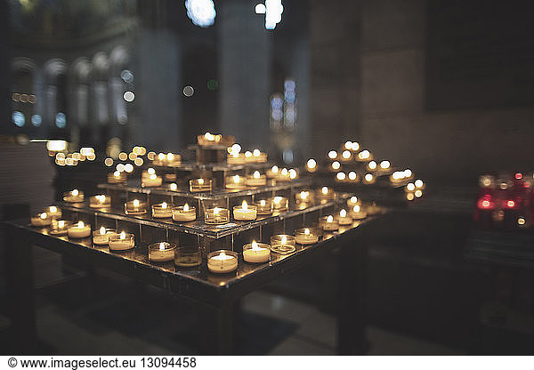 Tea light candles decorated on votive stand at church