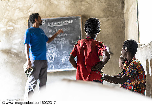 Teacher and kids in school classroom  Melabday  Asso Bhole  Danakil Depression  Afar Region  Ethiopia  Africa