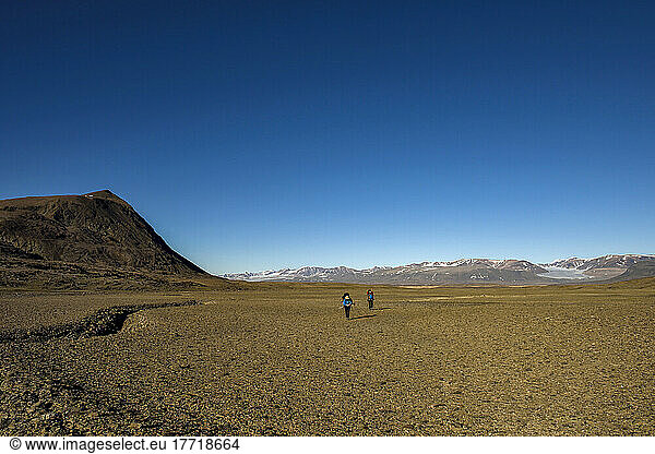 Team members on a climate change expedition explore a vast valley in Northeast Greenland; Greenland