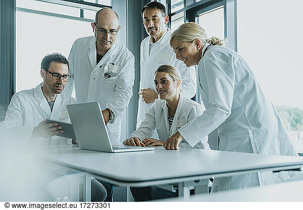 Team of doctors and scientist using laptop while working at office