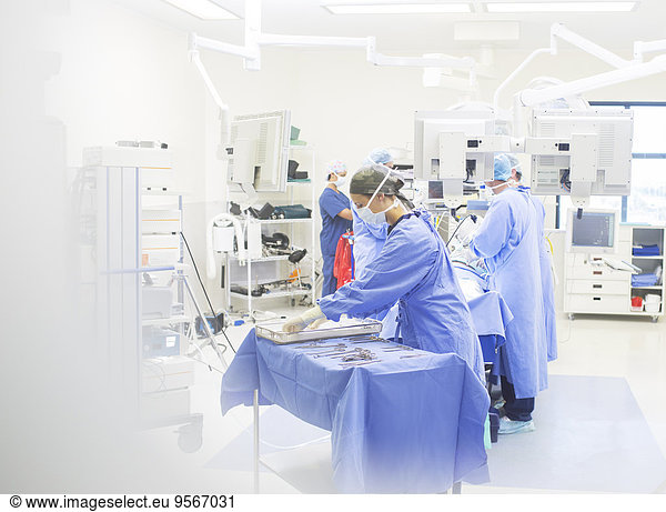 Team of surgeons performing surgery in operating theater