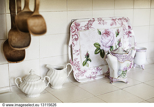Teapots and trays on kitchen counter