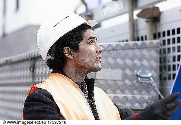 Technician wearing hardhat working outdoors