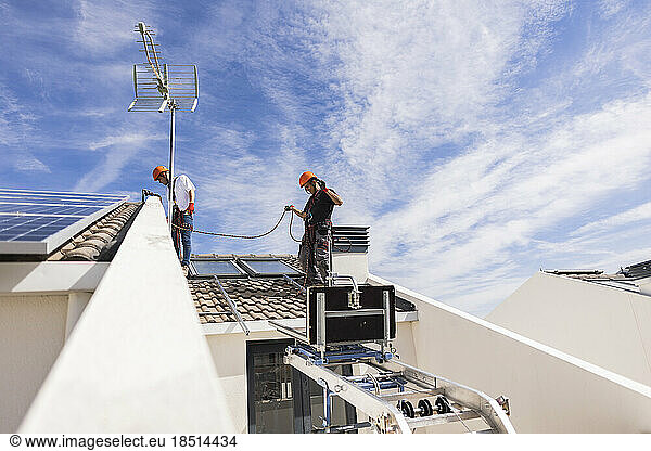 Technicians working together on rooftop