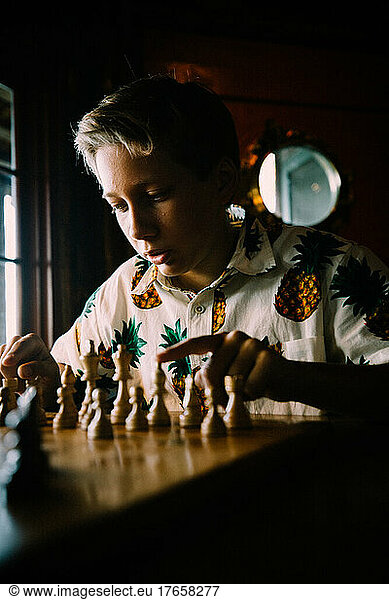 Teen Boy Contemplates Next Move in a Chess Game