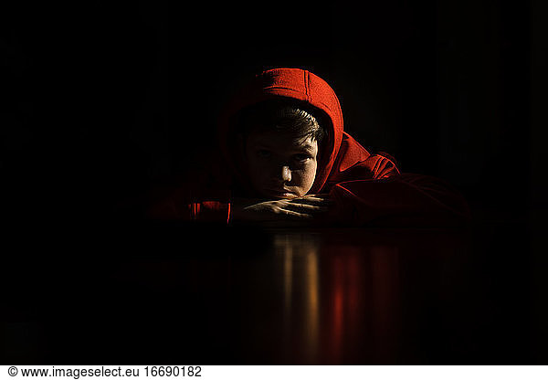 Teen boy on stomach with reflection on floor
