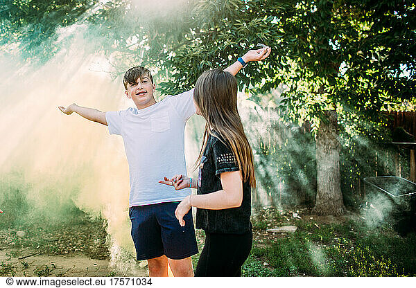 Teen boy smiling and playing in smoke bomb