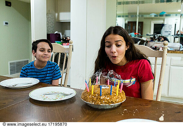 Teen Girl Blows Out Candles On Birthday Pie