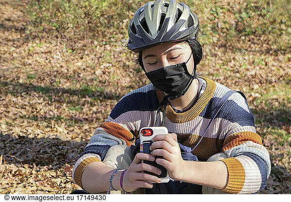 Teen Girl with Protective Mask Texting