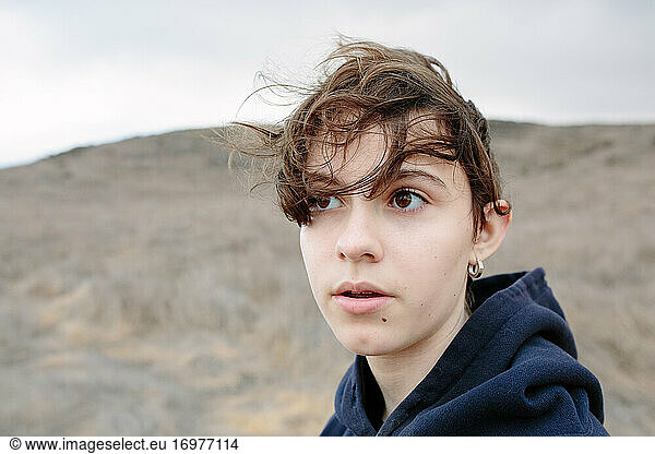 Teen Girl With Short Brown Hair Looks Pensive Outside While Hiking