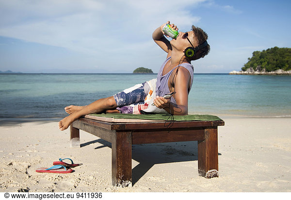teenage boy drinking lemonade at beach  Koh Lipe  Thailand