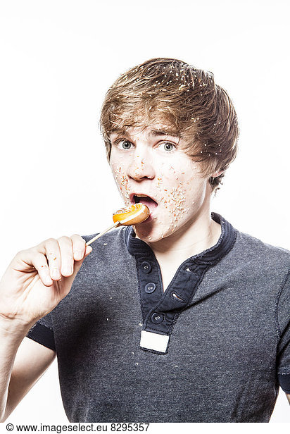Teenage boy eating lollipop