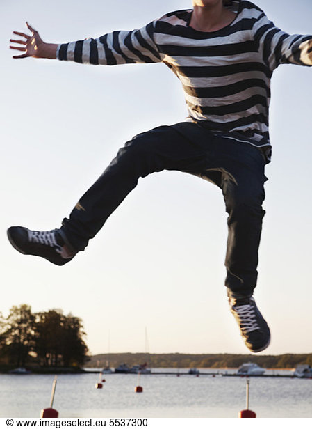 Teenage boy enjoying freedom while jumping