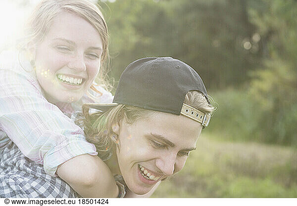 Teenage boy giving piggyback ride to his friend  Bavaria  Germany