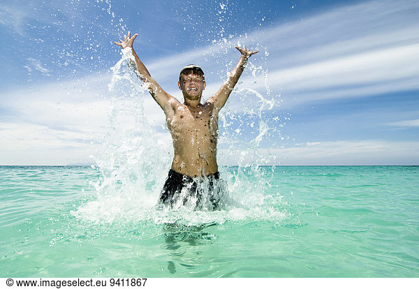 teenage boy jumping in the ocean  Koh Lipe  Thailand