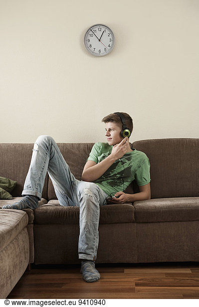 Teenage boy listening music at home