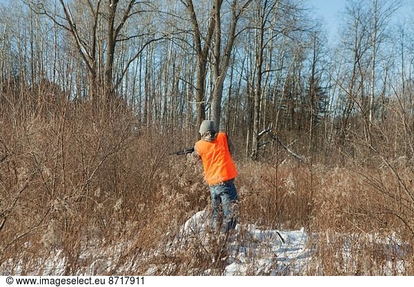Teenage boy shooting wildlife in Petersburg State Game Area  Michigan  USA