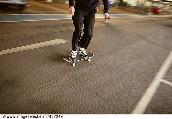 Teenage boy skateboarding on street
