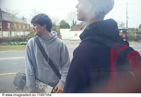 Teenage boys with skateboard on street