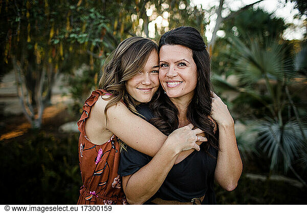 Teenage Daughter Embracing Mother in Garden in San Diego