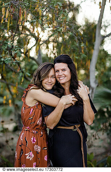 Teenage Daughter Embracing Mother in Garden in San Diego