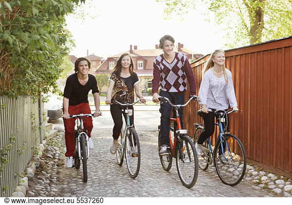 Teenage friends cycling together