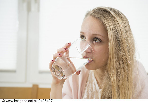 Teenage girl drinking water  close up