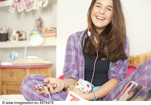 teenage girl listening to music in pajamas